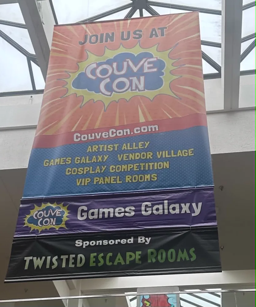 CouveCon banner at Vancouver Mall reading Sponsored By Twisted Escape Rooms